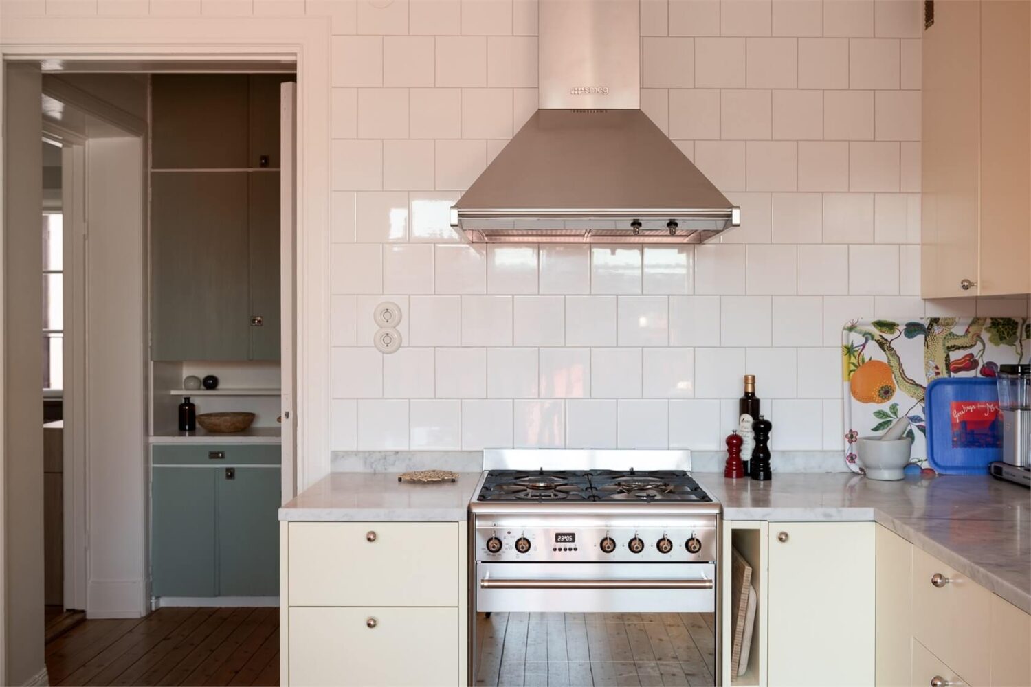A Stockholm Apartment with a Light Yellow Kitchen 7 pale yellow kitchen cupboards white tiles