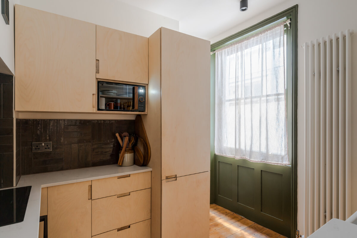 Contemporary Design in a Victorian Ground Floor Apartment 6 ply kitchen black backsplash tiles