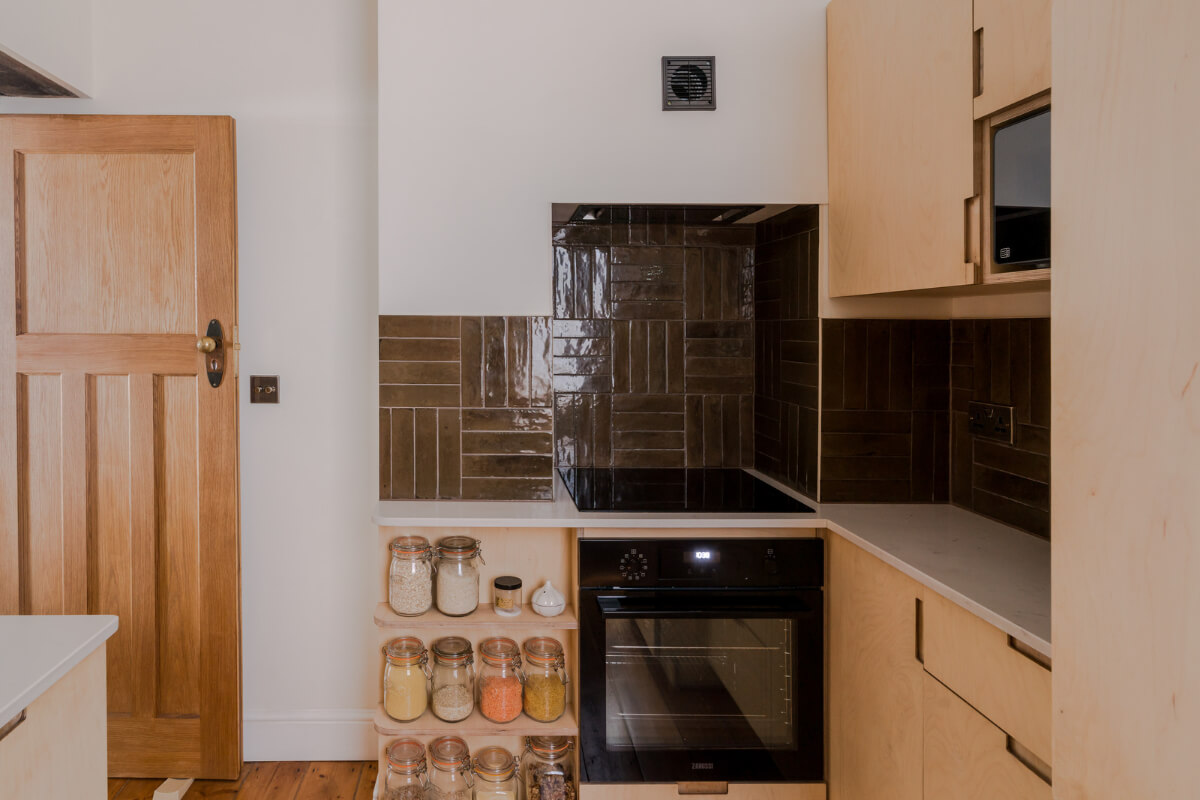 Contemporary Design in a Victorian Ground Floor Apartment 7 ply kitchen dark backsplash tiles