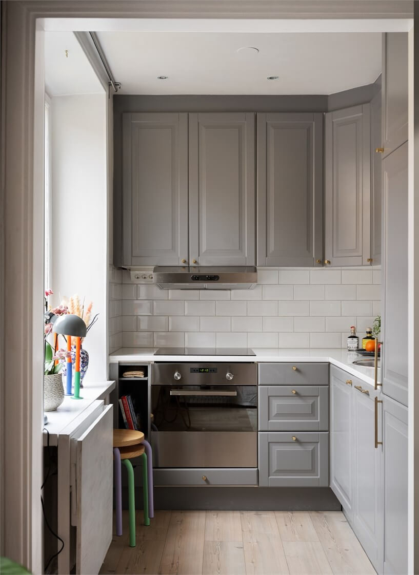 A Studio Apartment with Brown Walls 10 small gray kitchen with foldable table