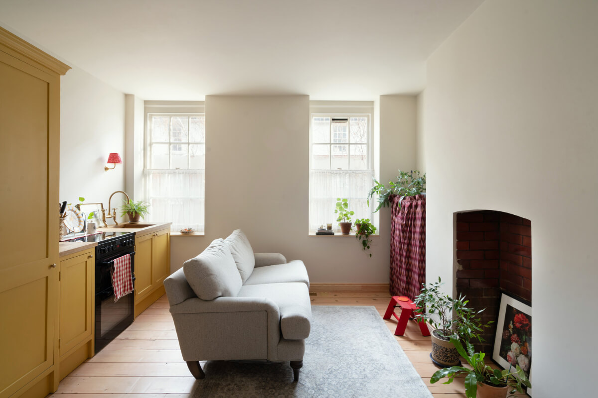A Tiny Apartment with a Yellow Kitchen in London 1 small living room with ochre yellow kitchen