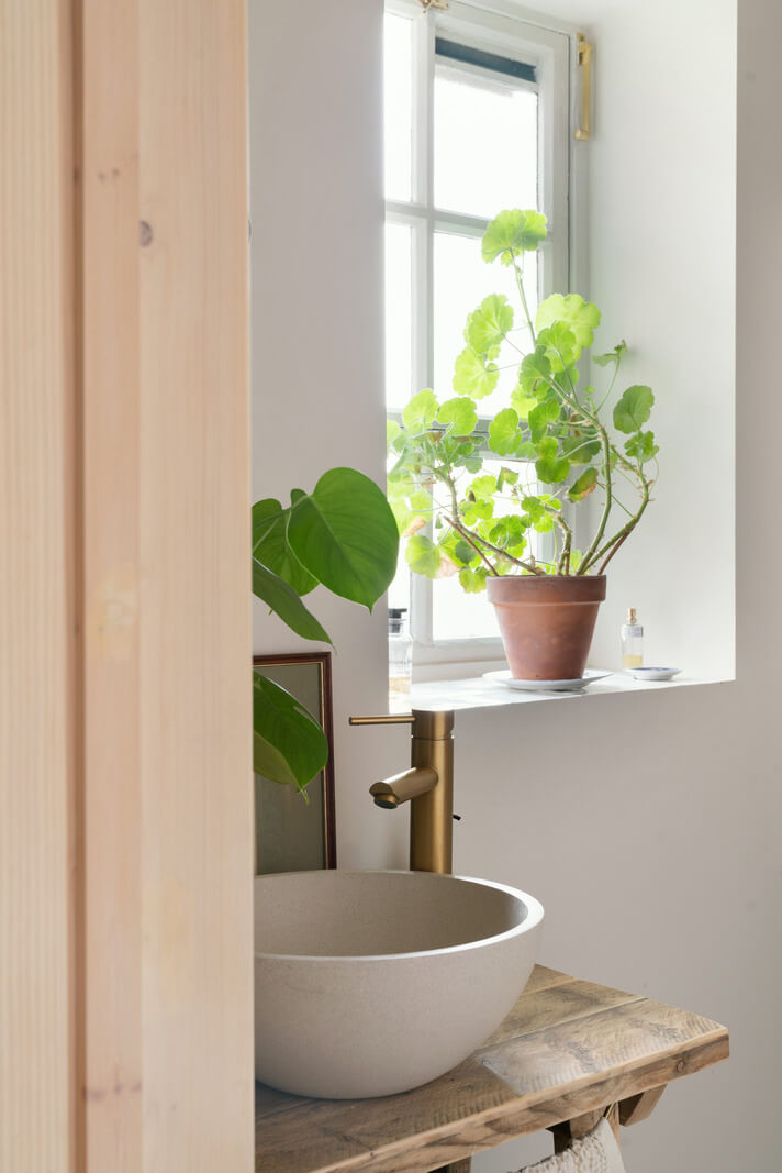 small round bathroom sink on rustic wooden top