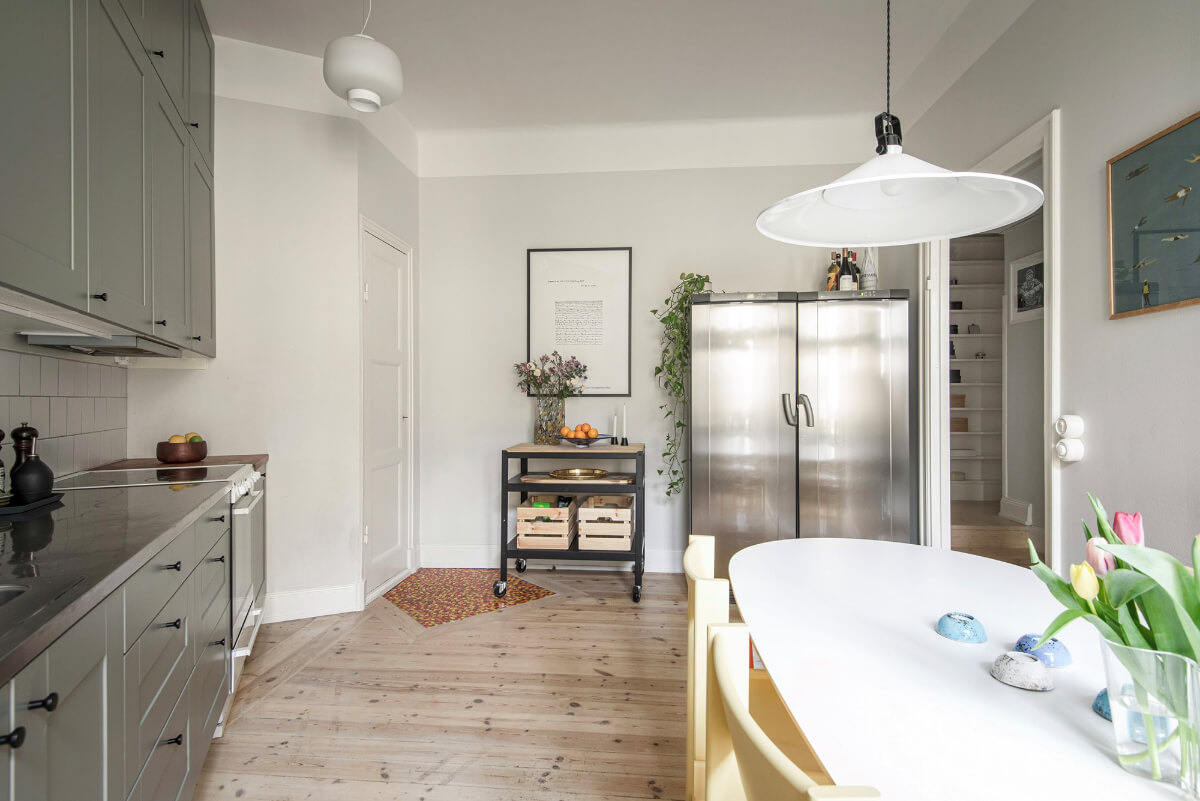 Rooms with Unique Shapes in a Lovely Swedish Apartment 15 spacious angled kitchen with table