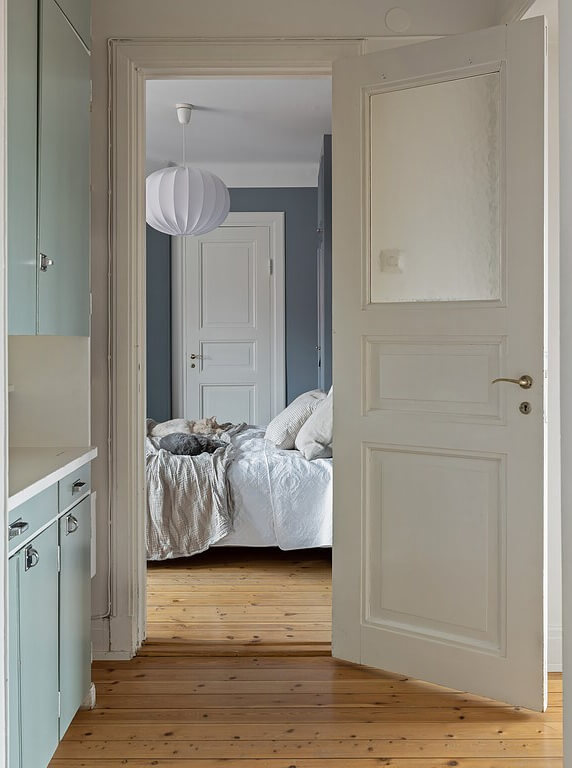 A Stockholm Apartment with a Light Yellow Kitchen 16 view into bedroom