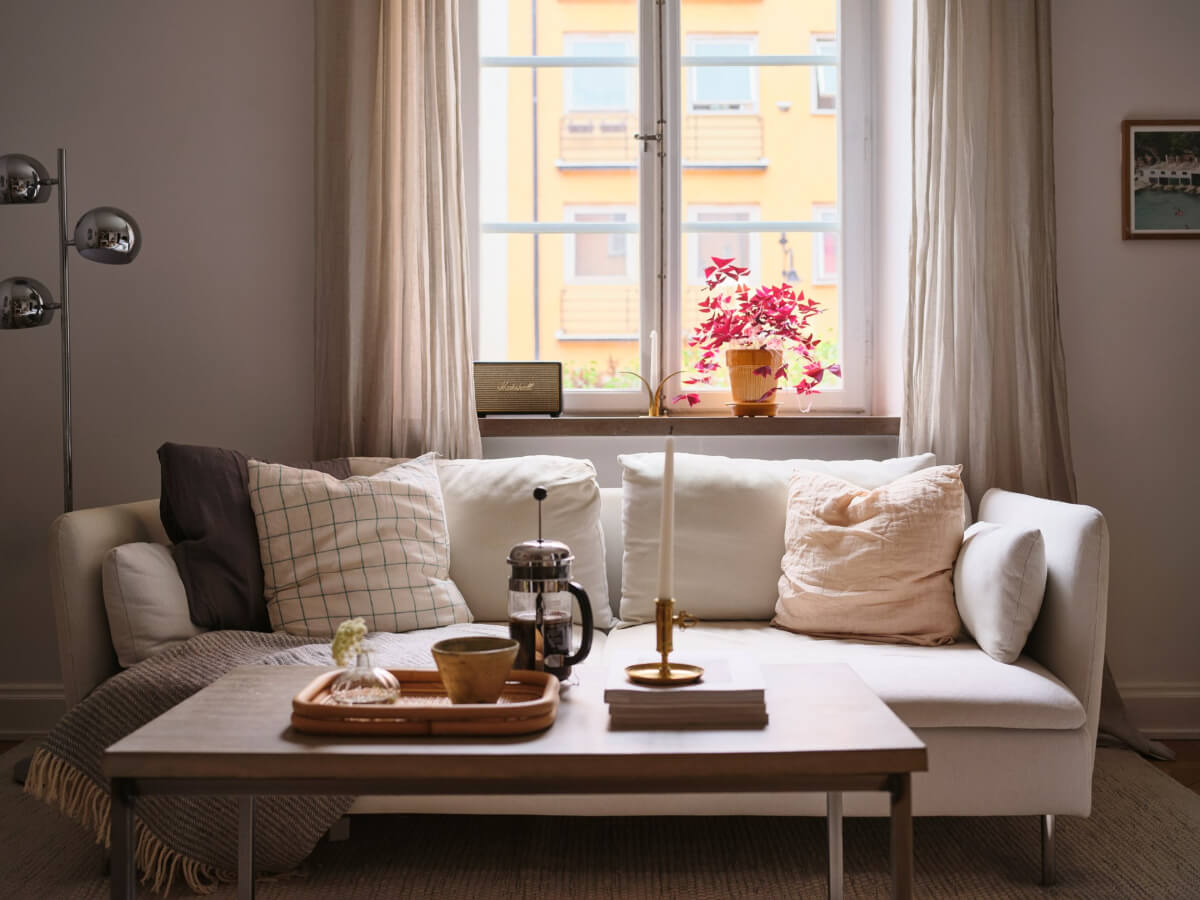 A Small Apartment with an Industrial Stainless Steel Kitchen 5 white sofa small living room