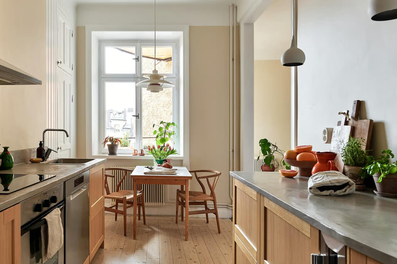 A Charming Swedish Apartment with a Spacious Balcony 12 wooden galley kitchen table under window
