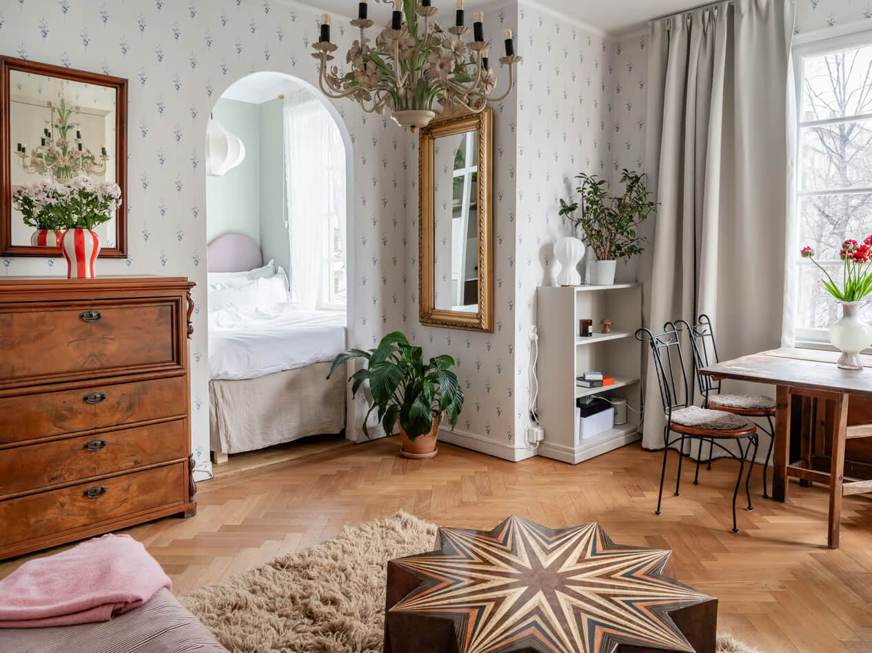 apartment parquet floor blue wallpaper arched doorway to bedroom