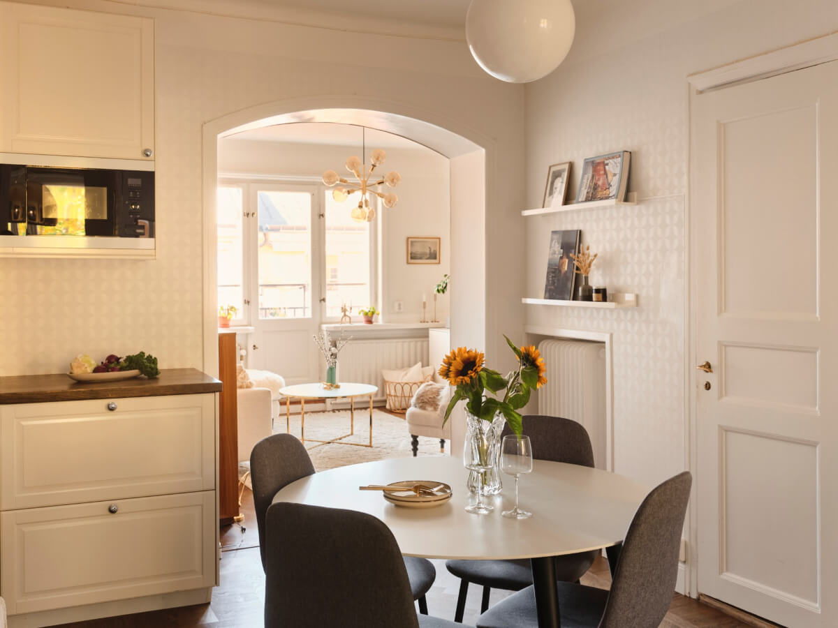 A Light-Filled 1920s Apartment with Two Spacious Balconies 10 arched doorway between kitchen and living room