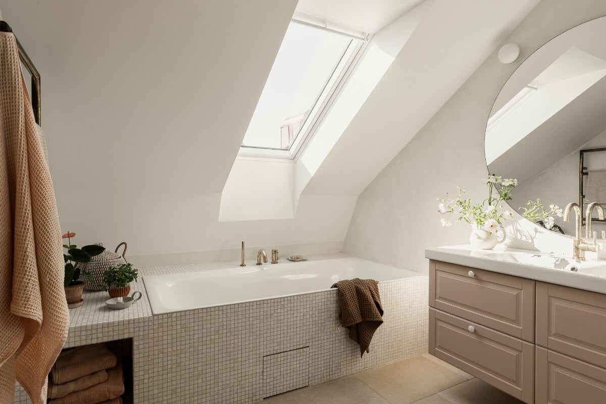 A Swedish Duplex Apartment Inspired by A Danish Summer House 15 bath under slanted ceiling with skylight