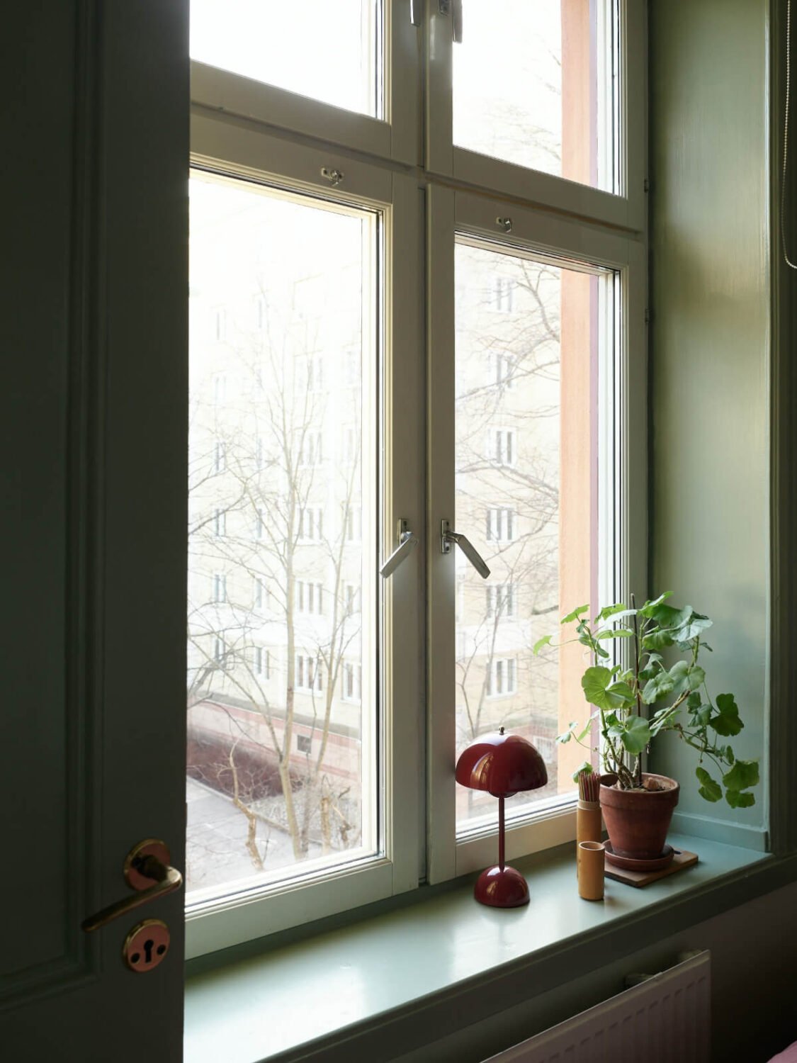A Muted Color Palette and Smart Storage in a Small Stockholm Apartment 10 bedroom window green joinery