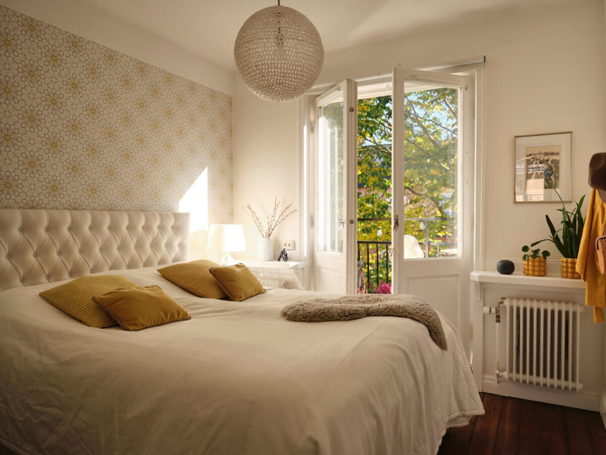 A Light-Filled 1920s Apartment with Two Spacious Balconies 19 bedroom with light wallpaper