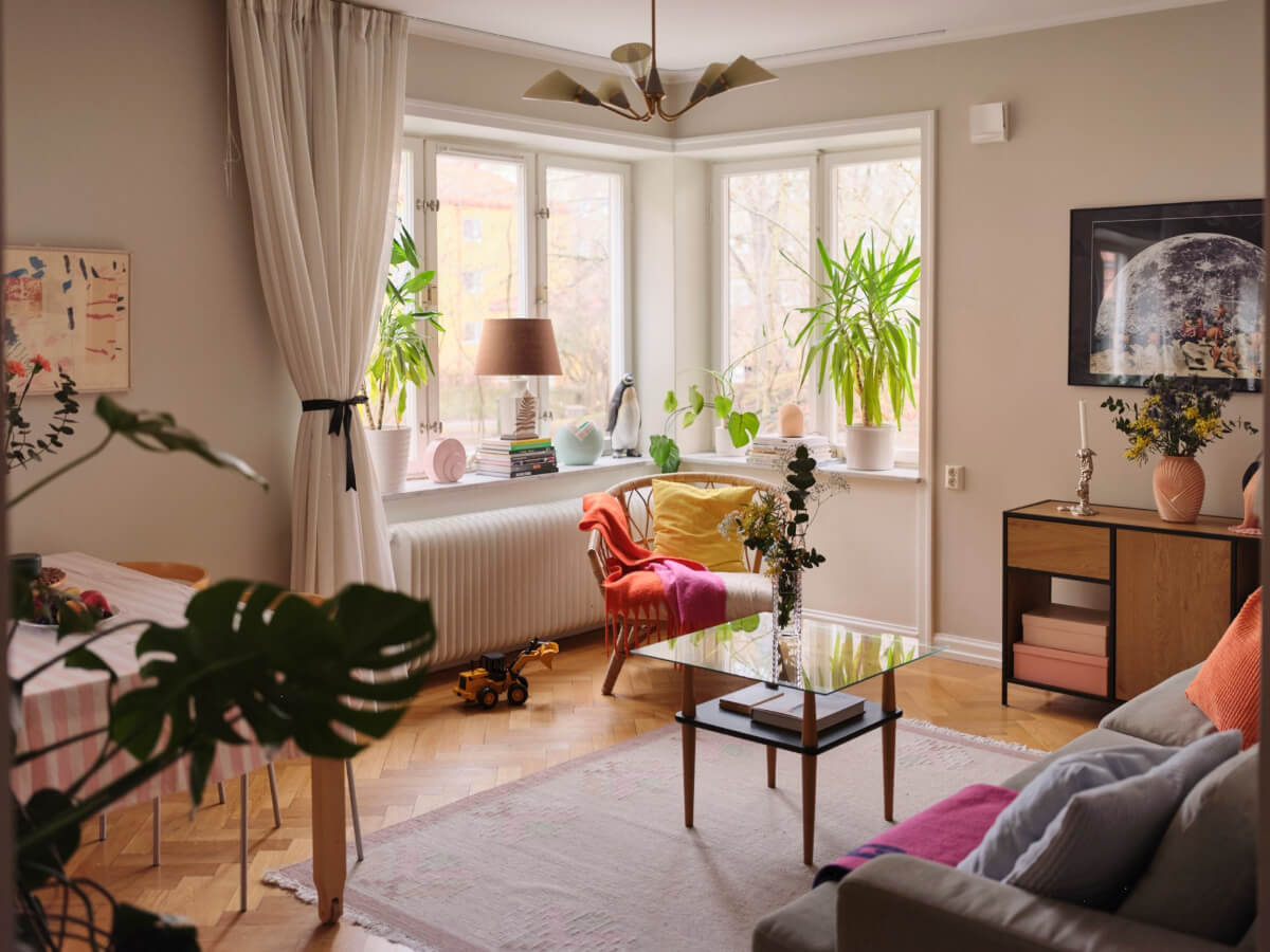 A Corner Apartment with Period Features and Bright Color Pops 2 beige living room corner window