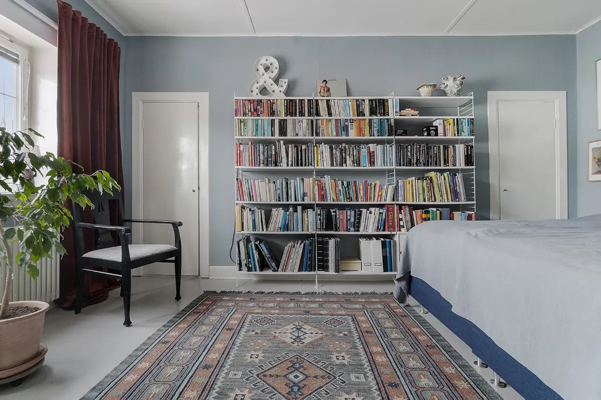 A Charming Early 20th-Century Family Home in Sweden 11 blue bedroom with bookshelves