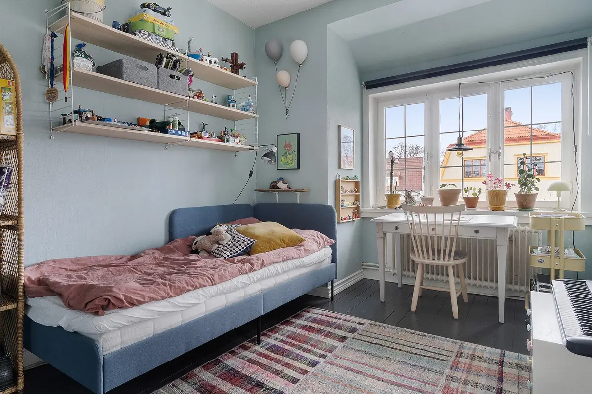 A Charming Early 20th-Century Family Home in Sweden 13 blue kids bedroom desk under window