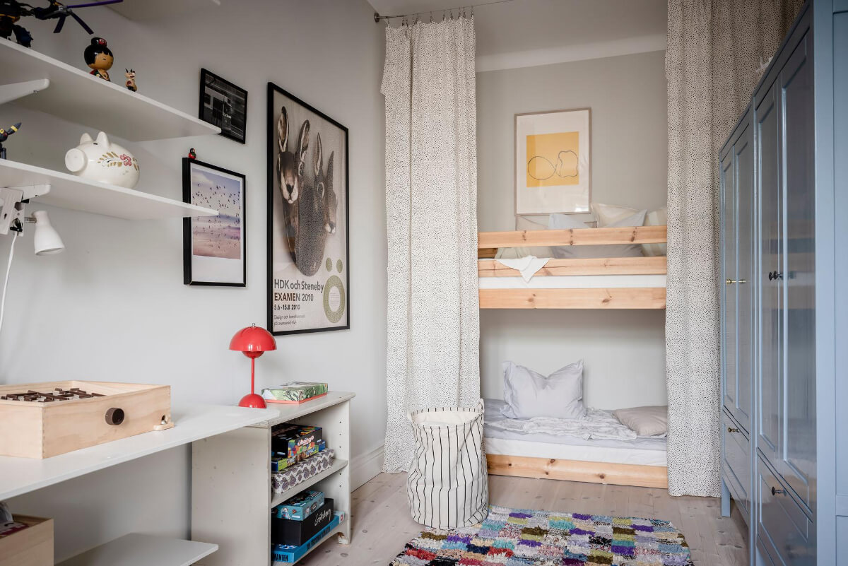 A Light Color Palette in a Stylish Renovated Late 19th Century Apartment 26 bunk beds behind curtain