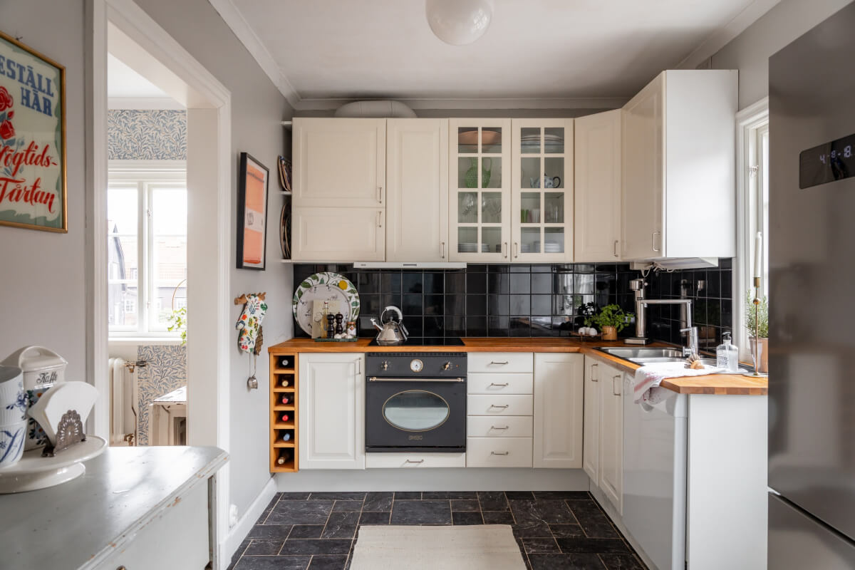 Turn-of-the-Century Charm Meets Modern Comfort in a Swedish House 13 classic white kitchen dark stone floor