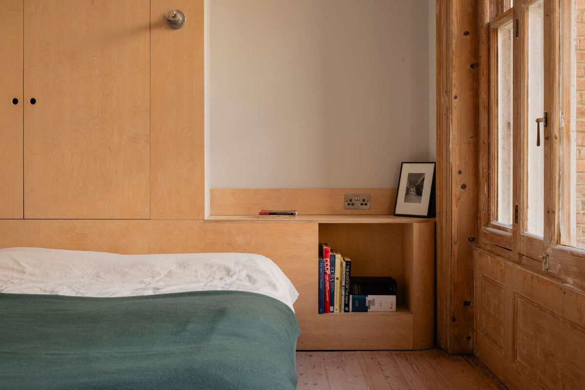 Bespoke Furniture in a Restored Seaside Apartment in England 17 custom birch ply headboard with wardrobes
