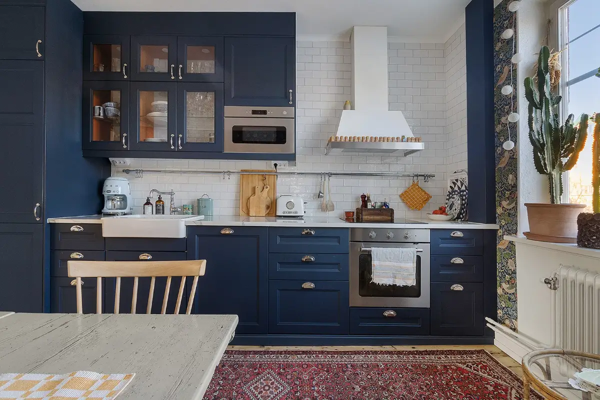 A Charming Early 20th-Century Family Home in Sweden 5 dark blue kitchen cabinets white tiles