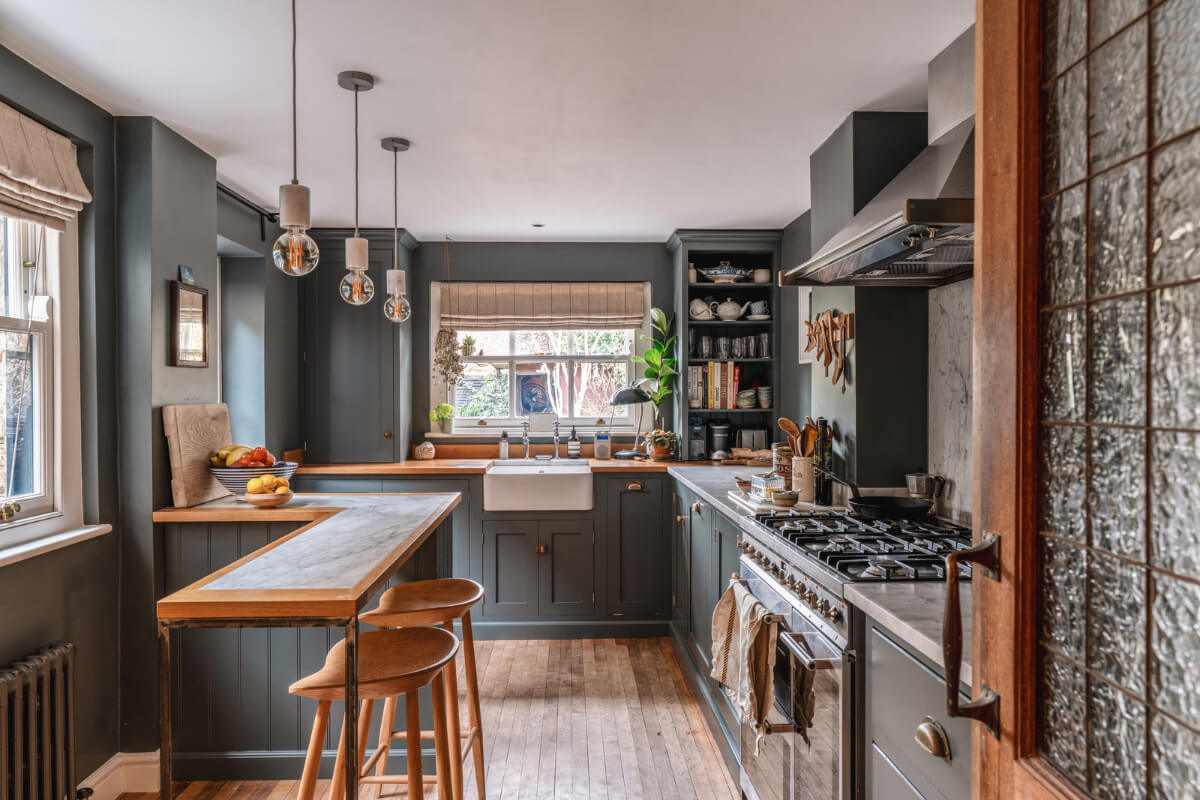 dark gray kitchen with wooden floor and bar seating
