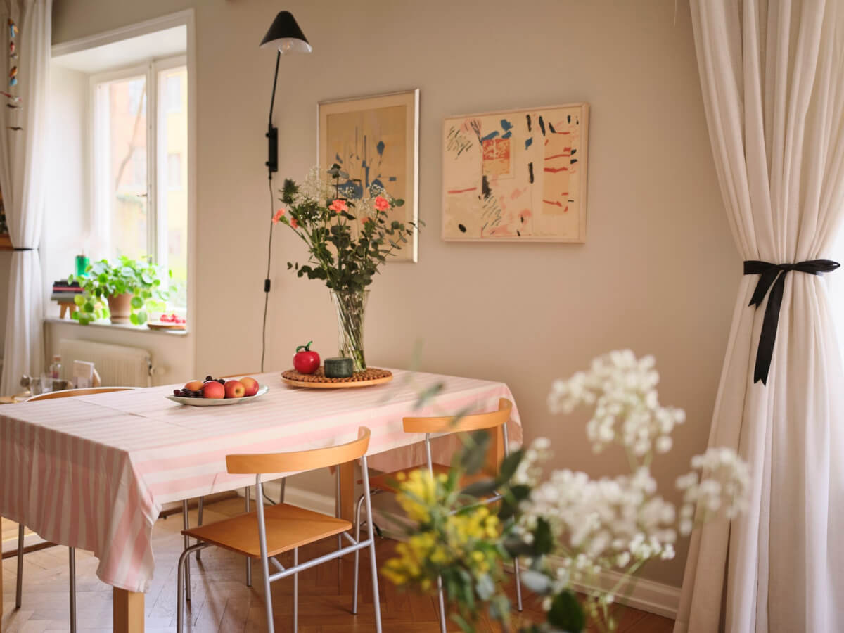 A Corner Apartment with Period Features and Bright Color Pops 6 dining-table-pink-striped-tablecloth