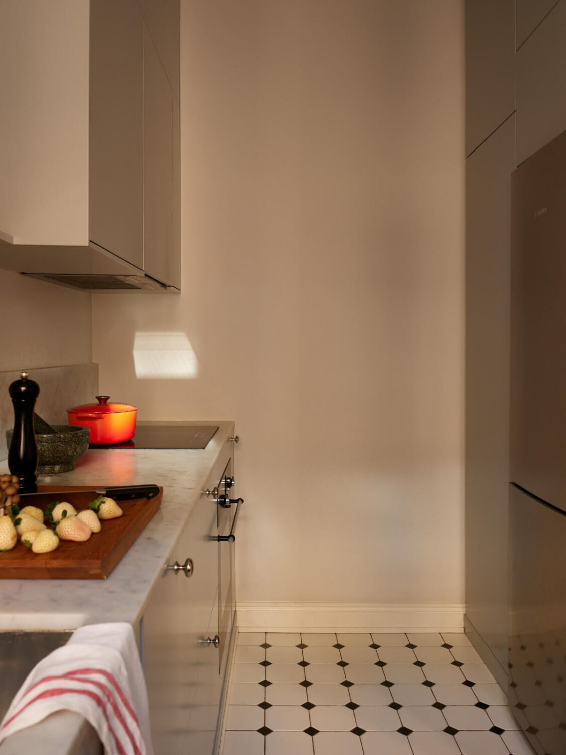 Revisiting a Bright Scandi Apartment with a Gray Kitchen 12 floor to ceiling kitchen cabinets