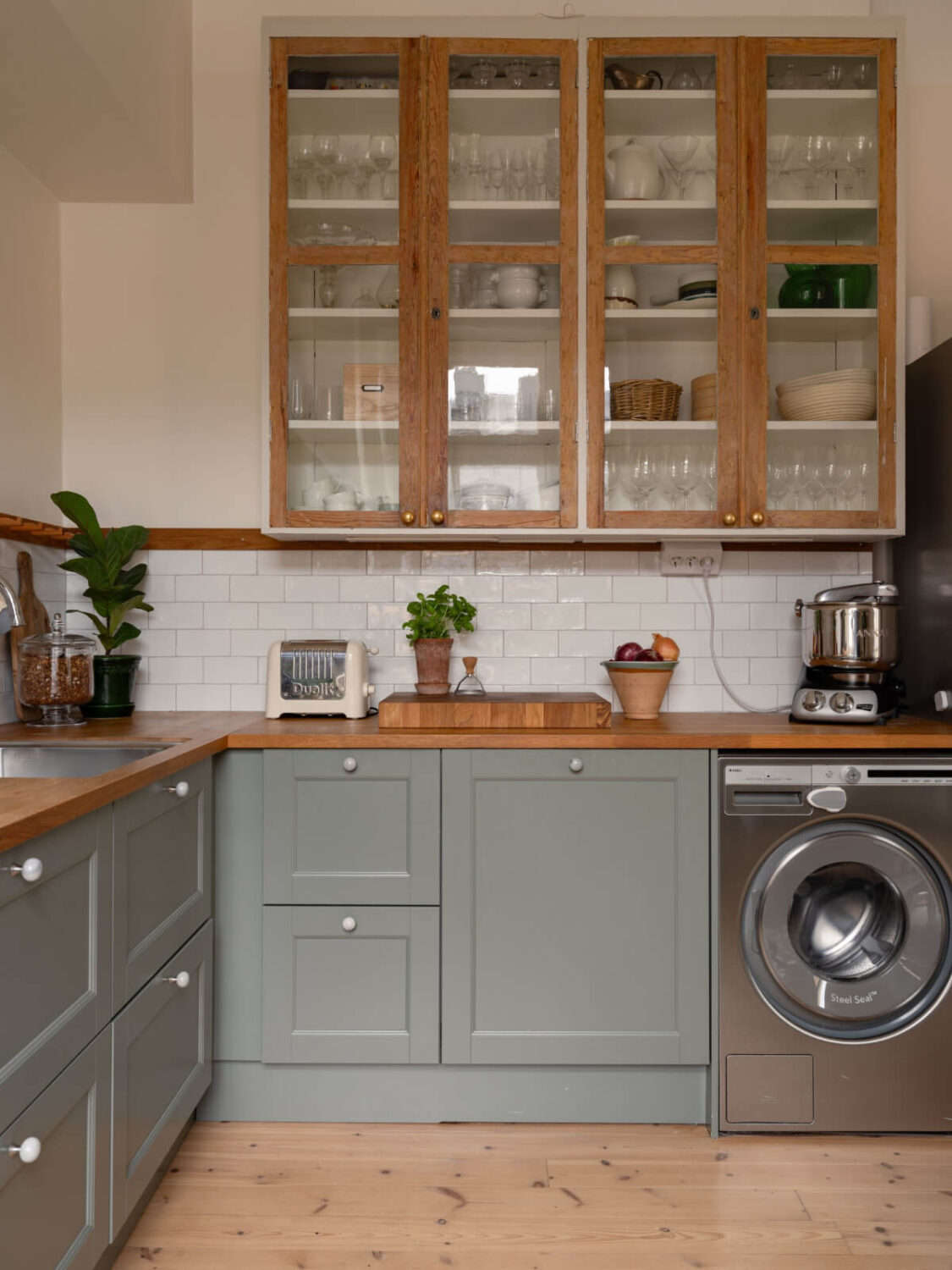 Soft Color Tones in a Renovated Turn-of-the-Century Apartment 8 glass wooden cabinets