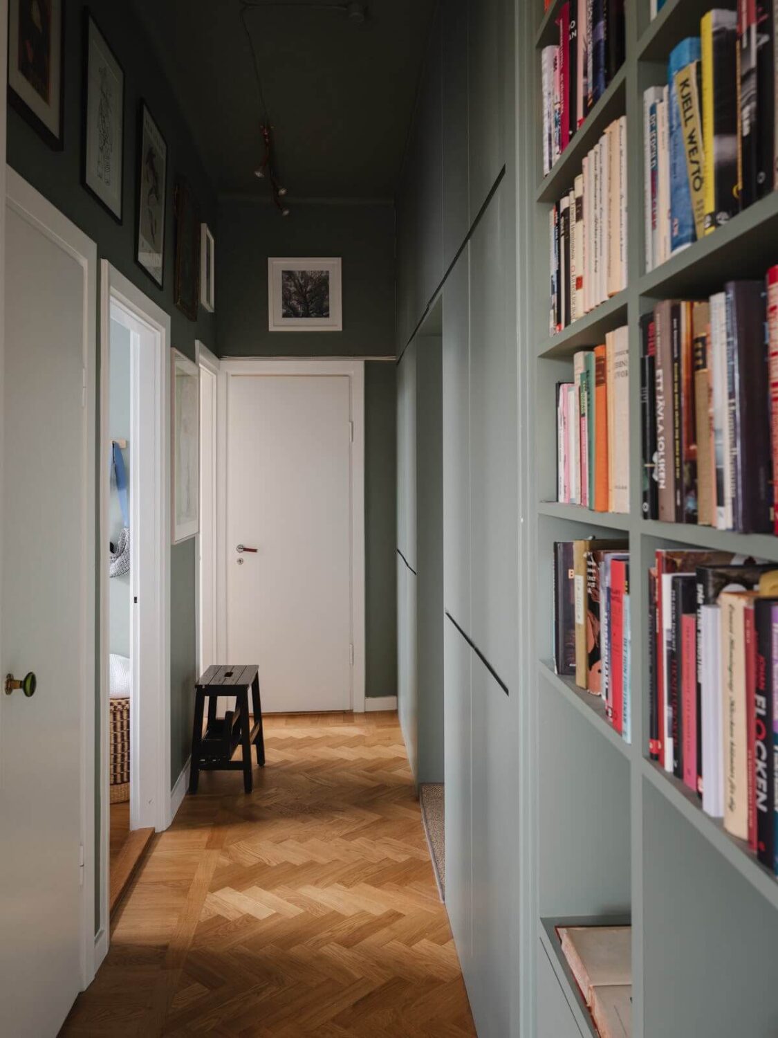 Gray Tones and Built-in Storage in a Charming Corner Apartment 9 green hall with built-in cabinets and bookshelves