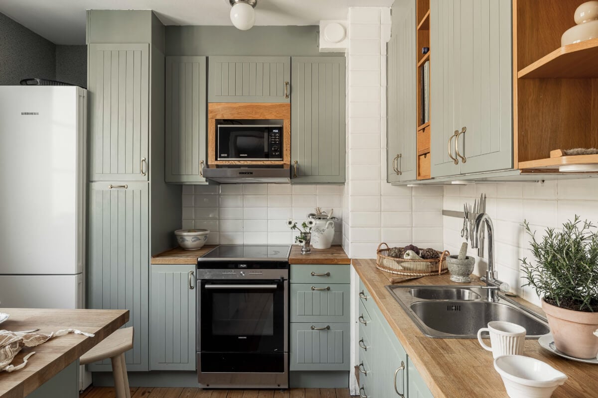 A Swedish Duplex Apartment Inspired by A Danish Summer House 24 green kitchen cabinets oak worktop