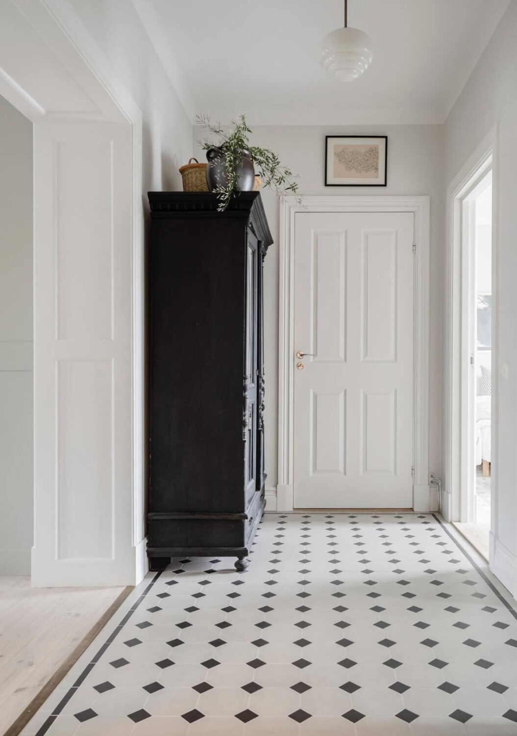 A Light Color Palette in a Stylish Renovated Late 19th Century Apartment 12 hall black and white floor tiles