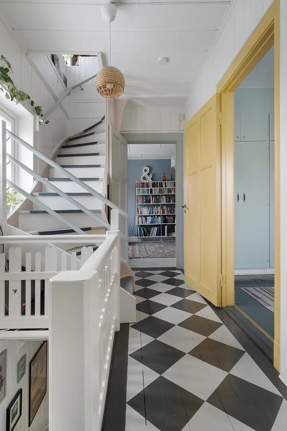 A Charming Early 20th-Century Family Home in Sweden 12 hall checkerboard floor yellow doors