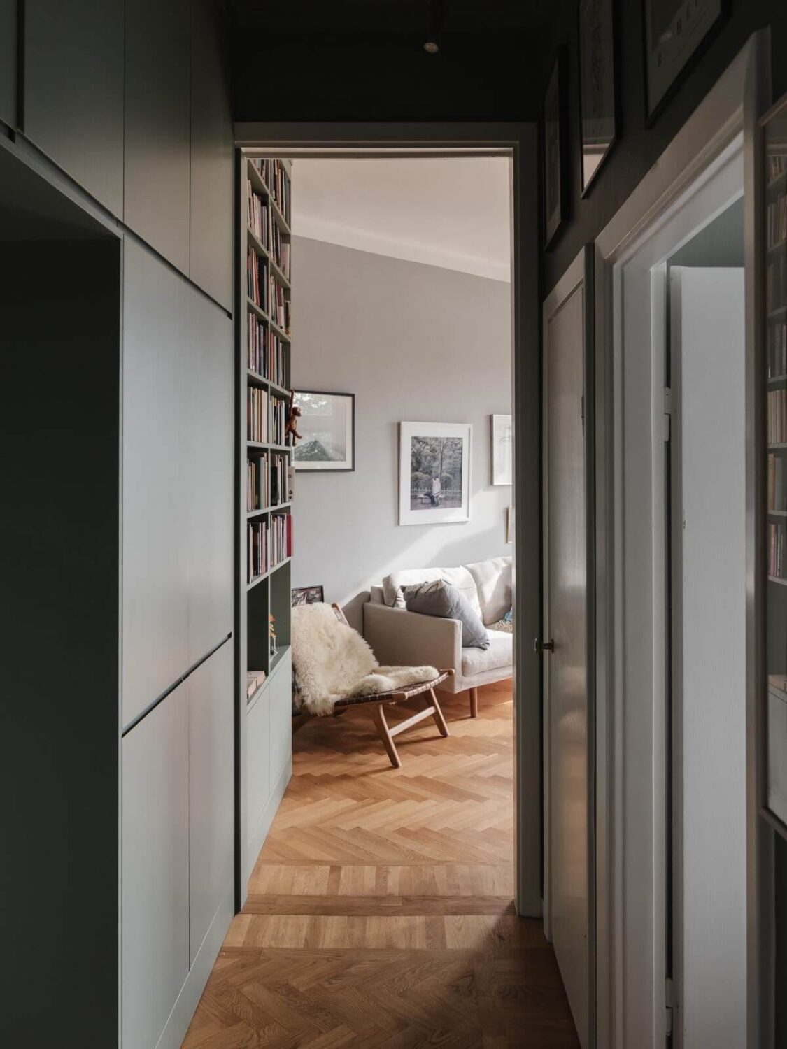 Gray Tones and Built-in Storage in a Charming Corner Apartment 8 hall view into living room