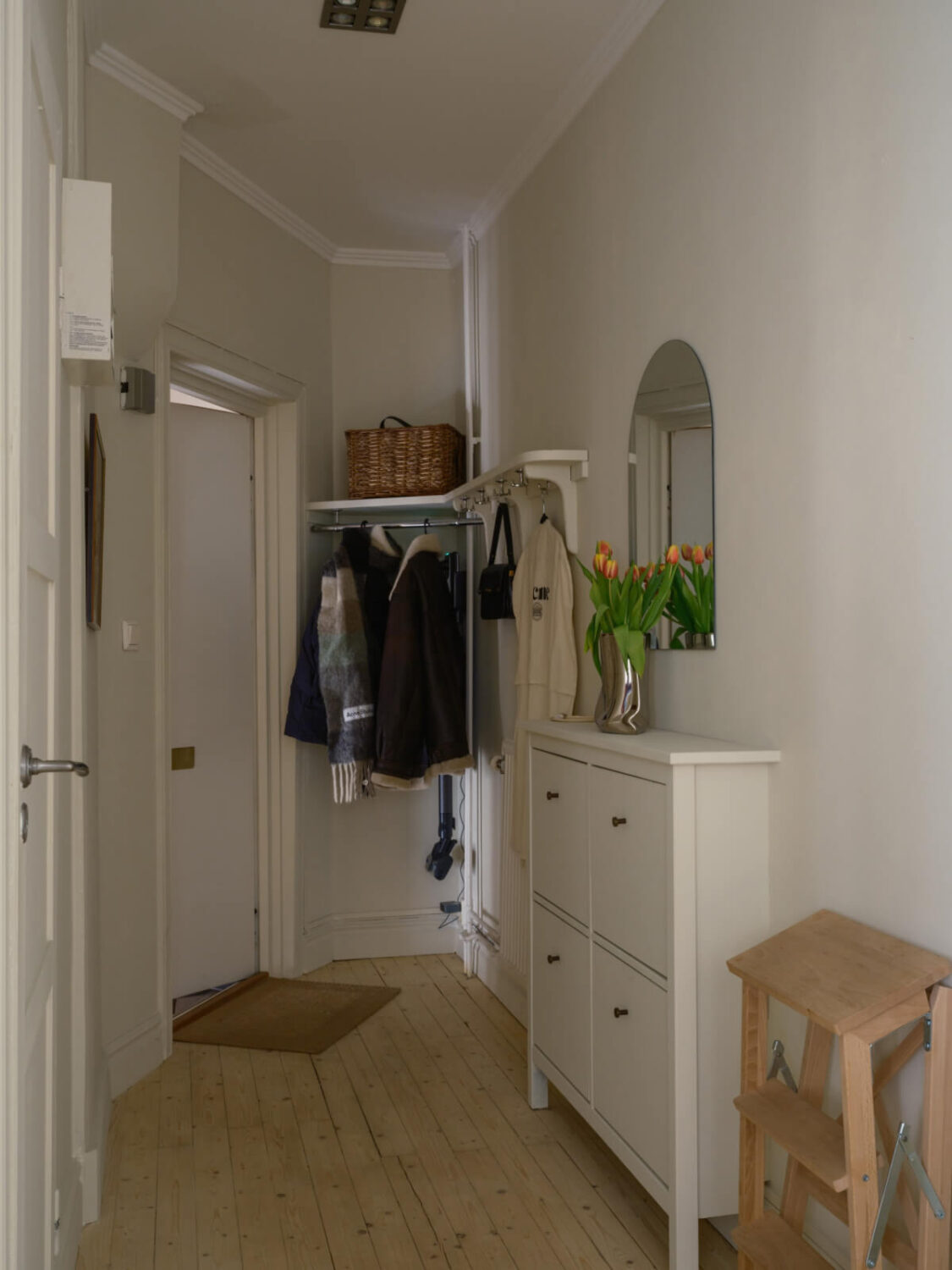 A Serene 19th Century Apartment with a Deep Red Kitchen 21 hall with hat rack and shoe cabinets