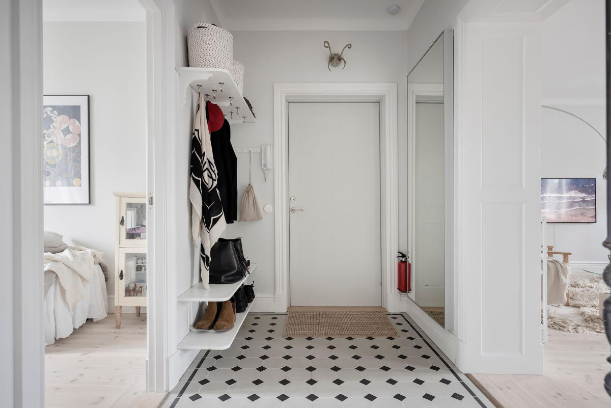 A Light Color Palette in a Stylish Renovated Late 19th Century Apartment 30 hall with tiles and shelves