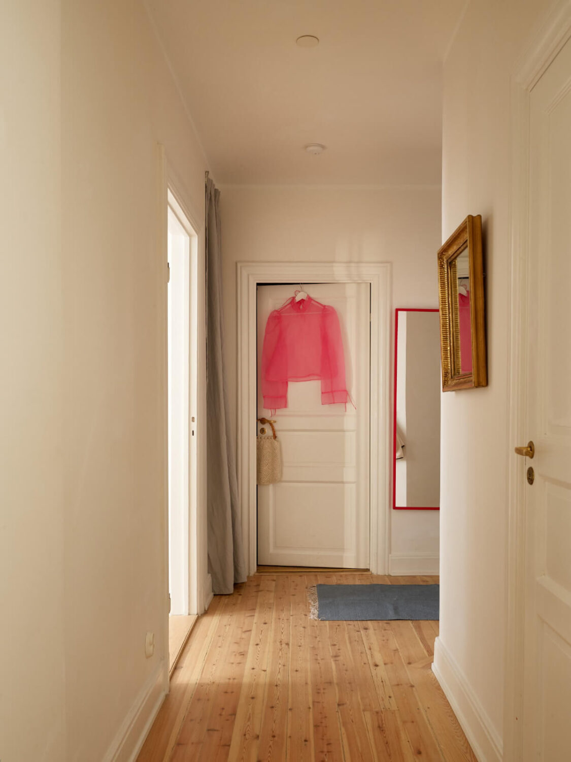 Revisiting a Bright Scandi Apartment with a Gray Kitchen 24 hall wooden floor