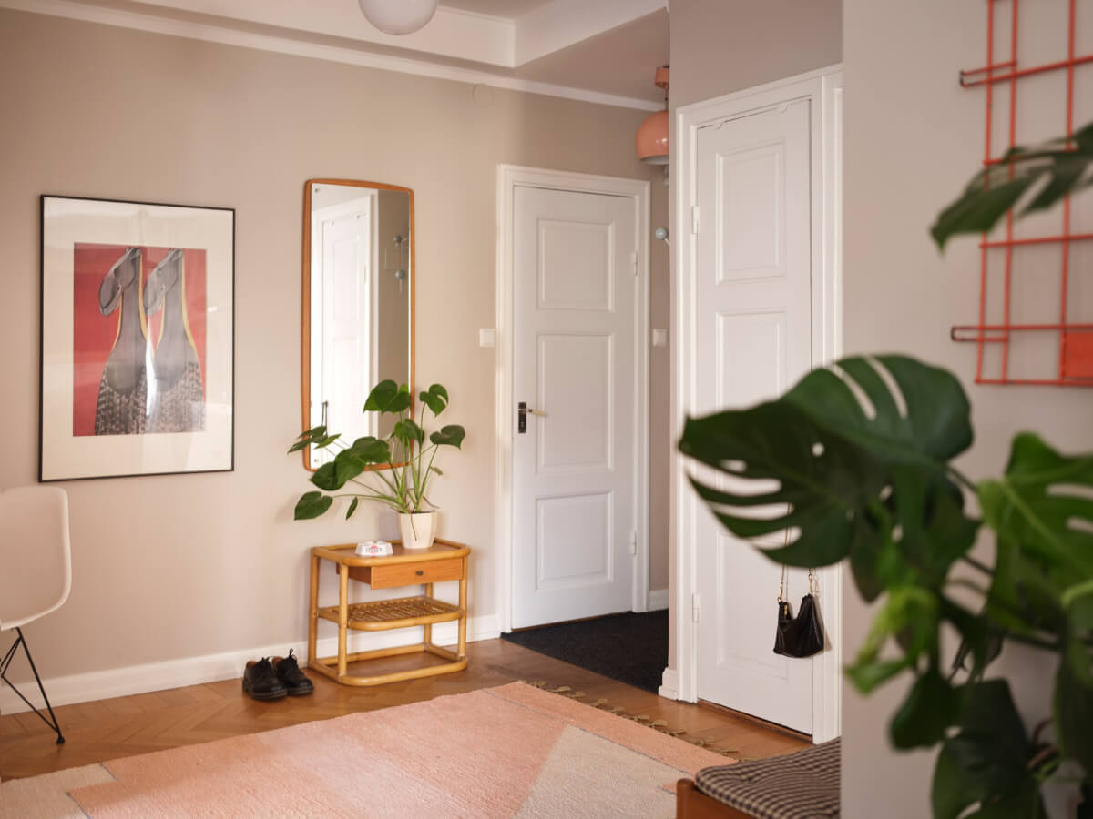 A Corner Apartment with Period Features and Bright Color Pops 22 inner hall with large pink rug and mirror
