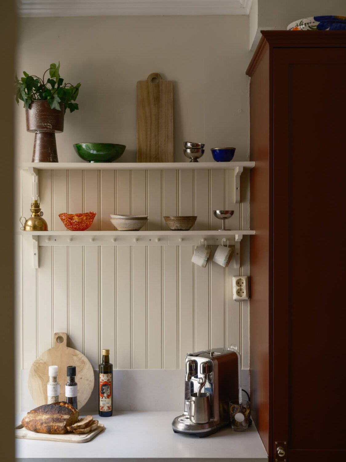A Serene 19th Century Apartment with a Deep Red Kitchen 11 kitchen tongue and groove paneling