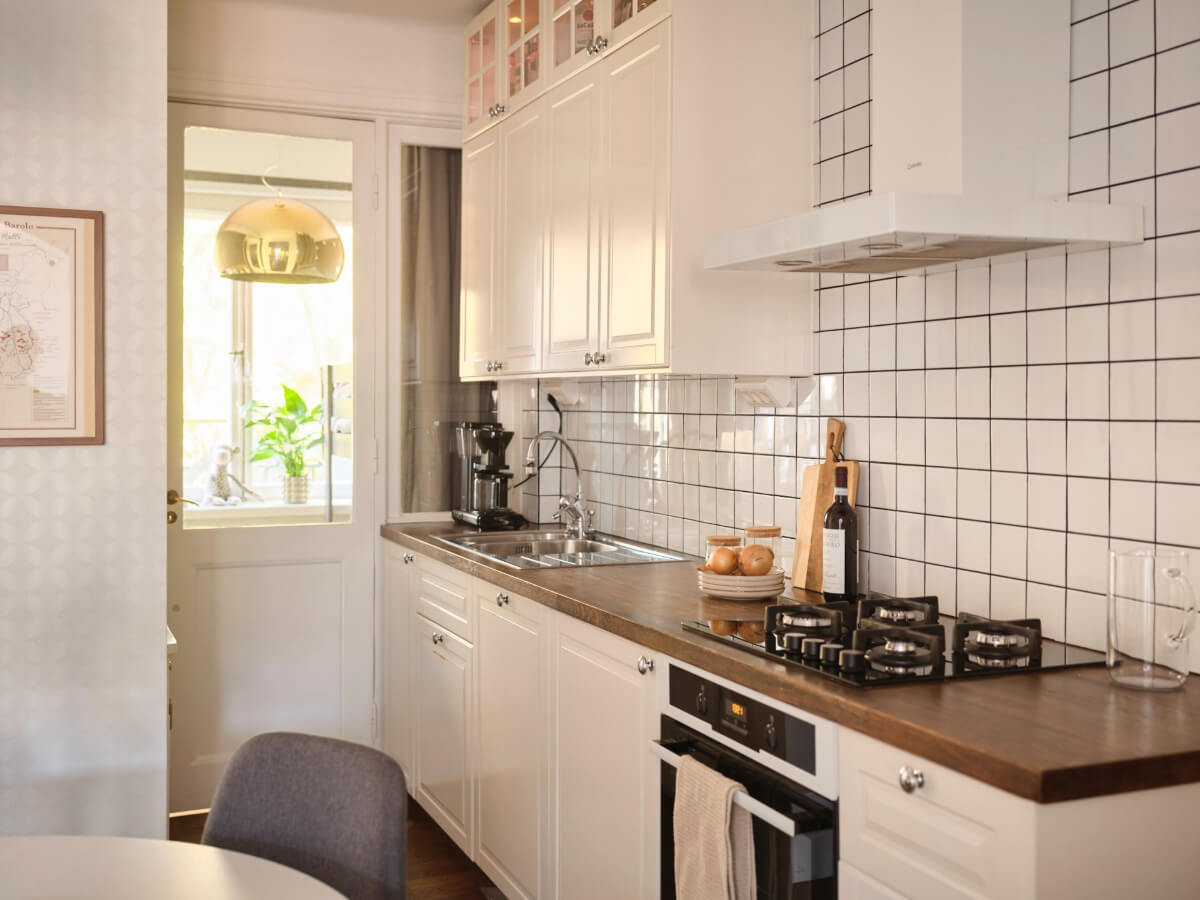 A Light-Filled 1920s Apartment with Two Spacious Balconies 14 kitchen white tiles wood countertop