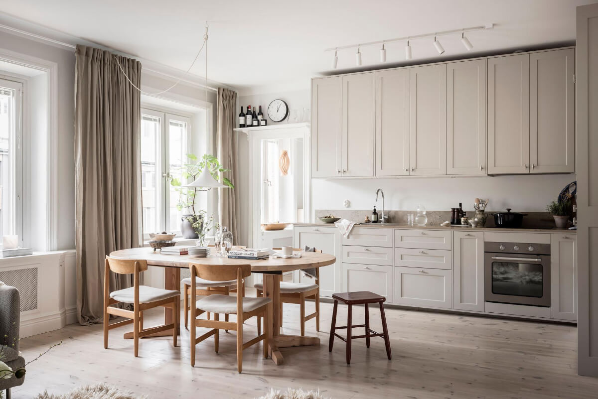 A Light Color Palette in a Stylish Renovated Late 19th Century Apartment 5 large kitchen high upper cabinets dining table