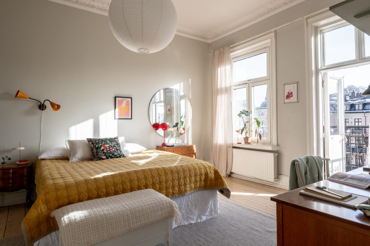 A Light and Spacious Apartment with a Cozy Social Kitchen 9 light bedroom round mirror yellow bedspread