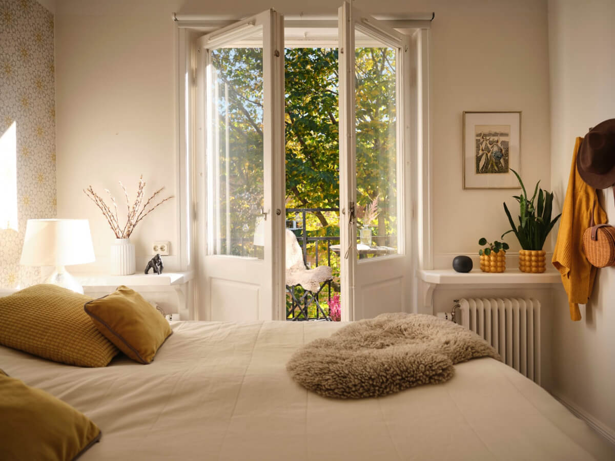 A Light-Filled 1920s Apartment with Two Spacious Balconies 20 light bedroom with glass balcony doors