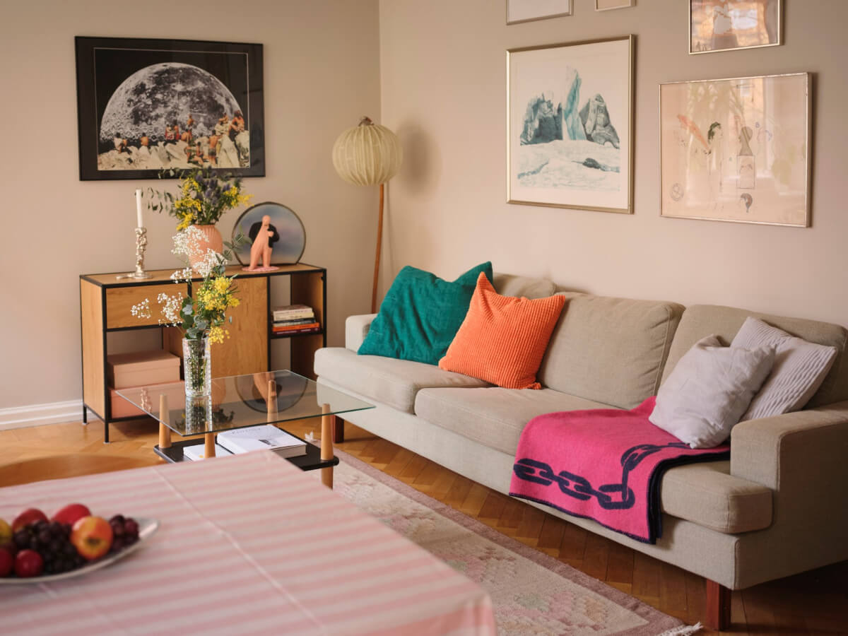 A Corner Apartment with Period Features and Bright Color Pops 3 living room beige walls colorful textiles
