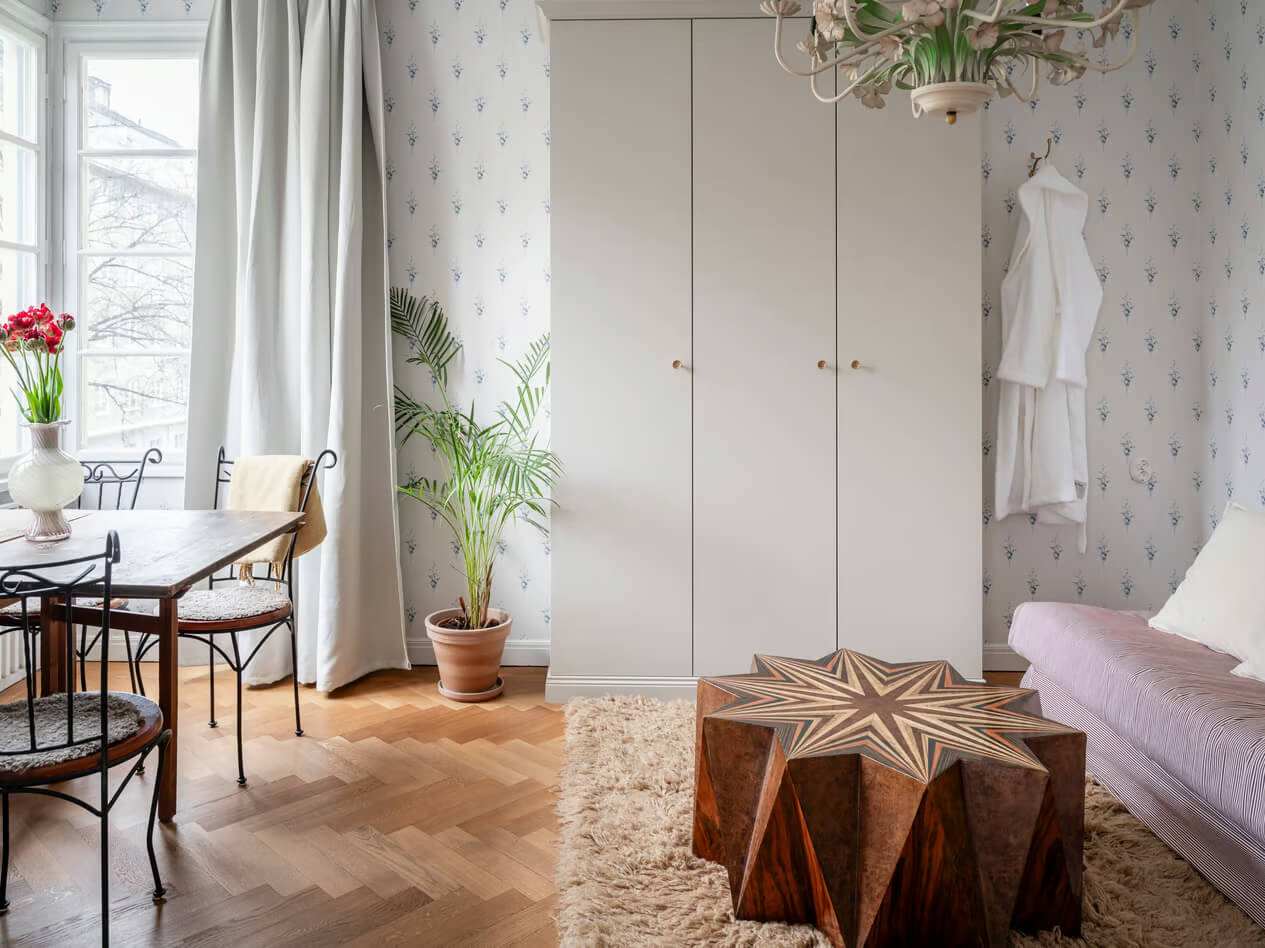 living room blue wallpaper herringbone parquet gray wardrobes