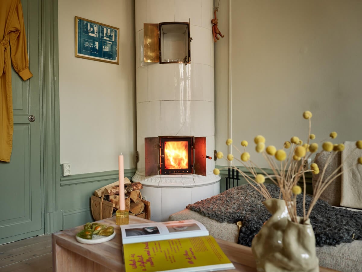 A Muted Color Palette and Smart Storage in a Small Stockholm Apartment 5 living room fireplace