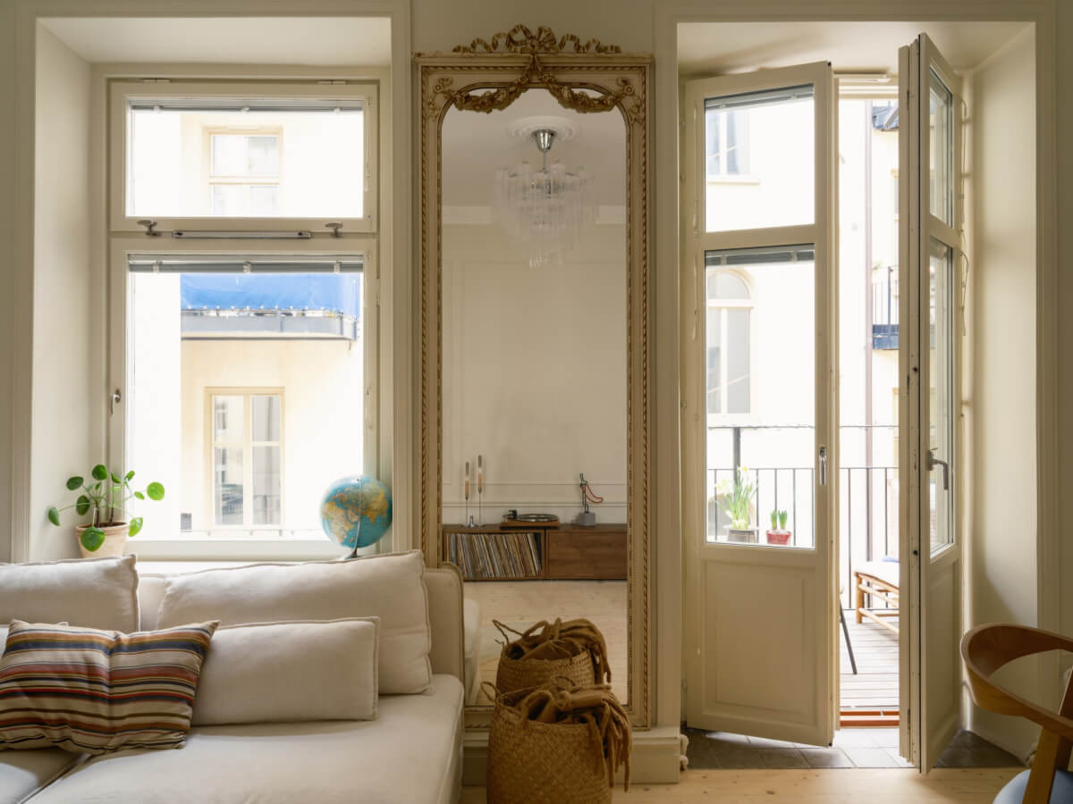 A Serene 19th Century Apartment with a Deep Red Kitchen 3 living room large mirror balcony doors