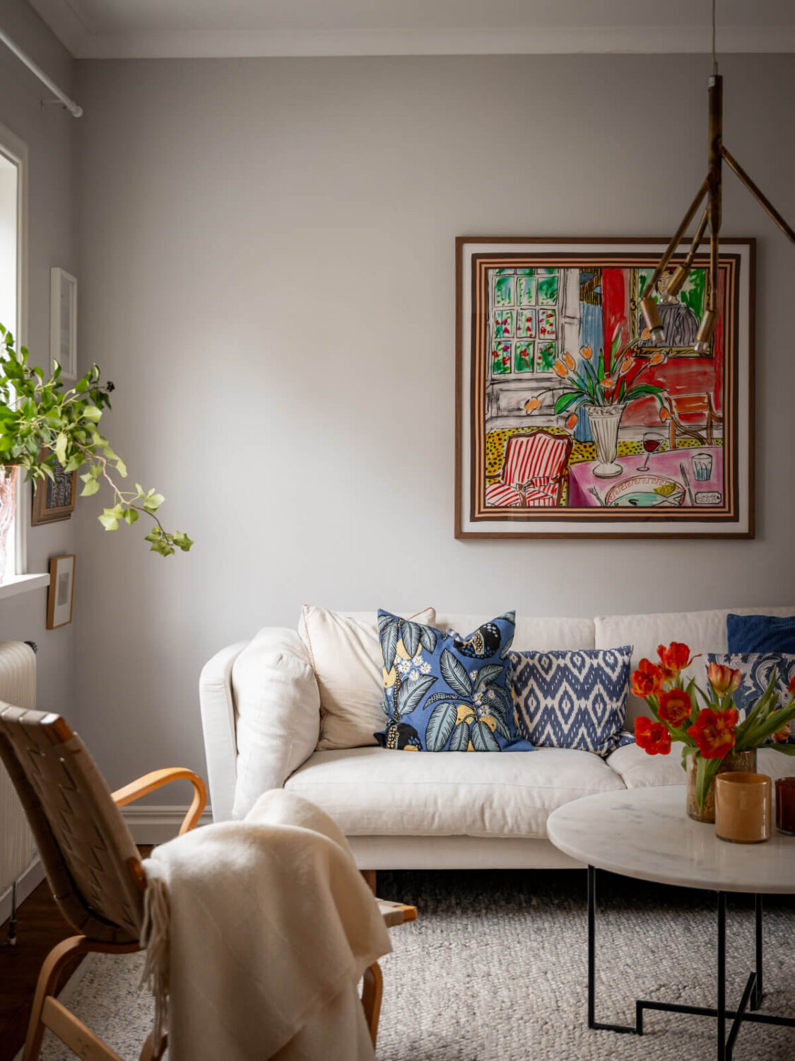 Turn-of-the-Century Charm Meets Modern Comfort in a Swedish House 3 living room light gray walls large rug