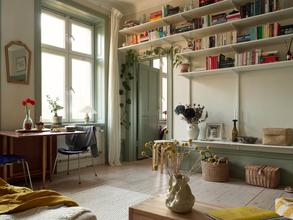 A Muted Color Palette and Smart Storage in a Small Stockholm Apartment 7 living room shelves