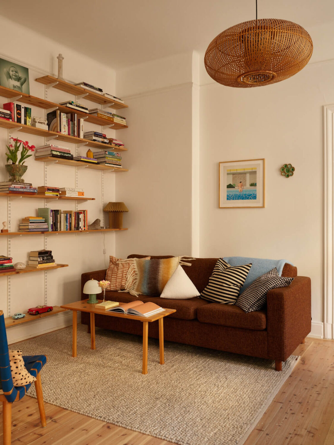 Revisiting a Bright Scandi Apartment with a Gray Kitchen 5 living room with bookshelves
