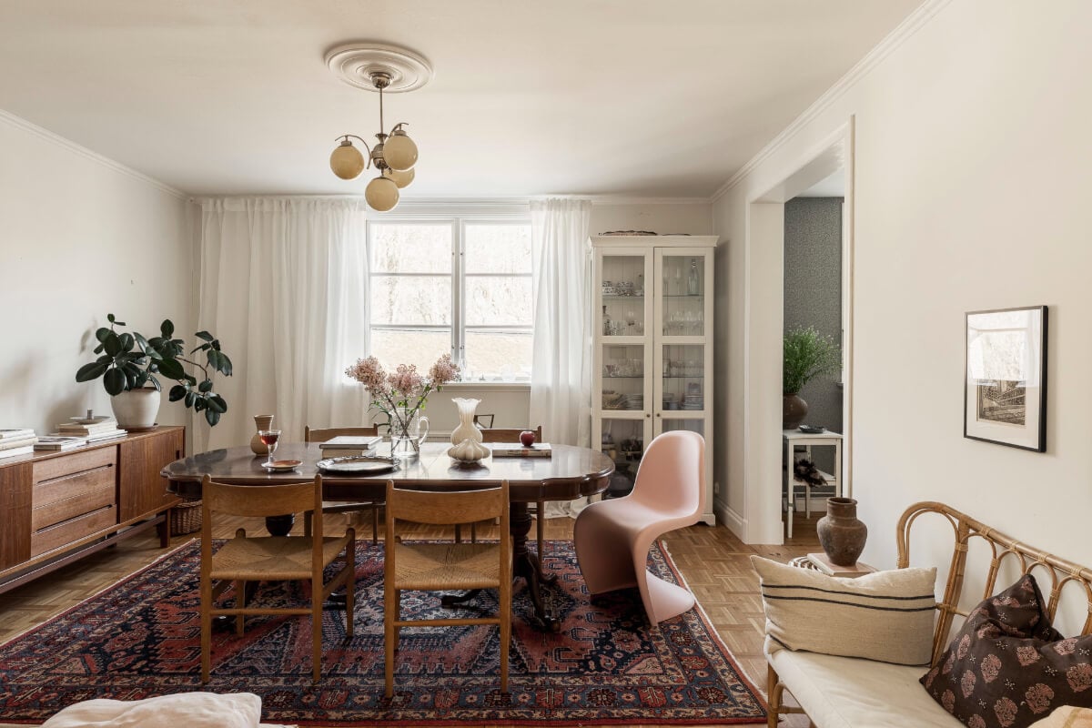 A Swedish Duplex Apartment Inspired by A Danish Summer House 18 living space with vintage rug and large antique dining table