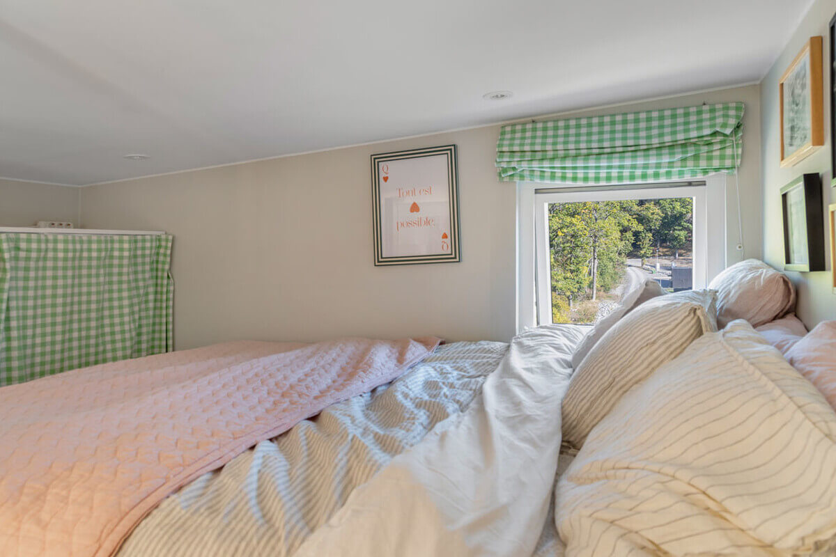 A Modern Tiny House in the Swedish Archipelago 10 loft bedroom green curtains