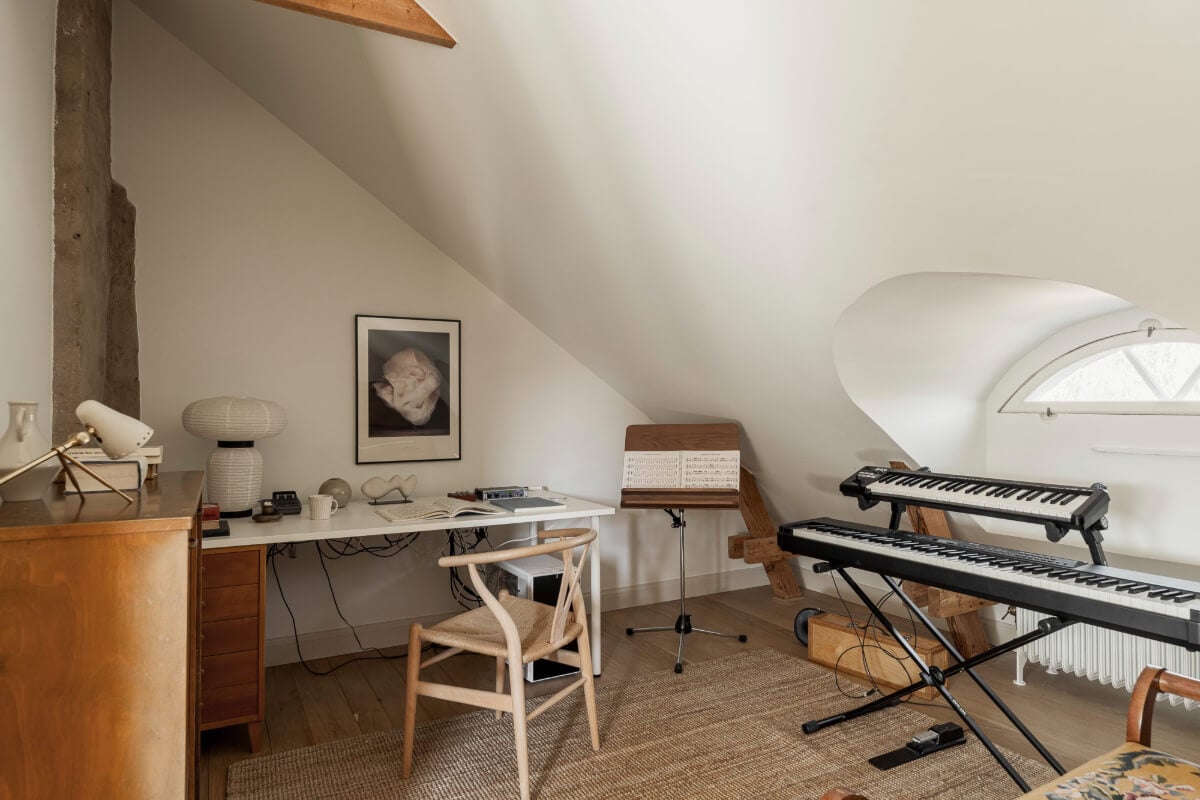 A Swedish Duplex Apartment Inspired by A Danish Summer House 12 music room slanted ceiling